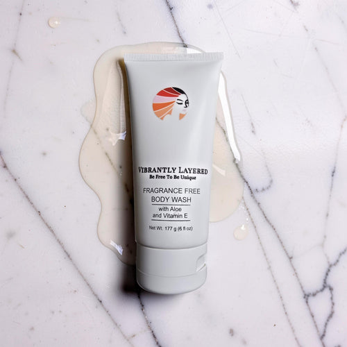 Fragrance-free body wash tube resting on a polished marble surface, showcasing its elegant packaging and clean aesthetic.